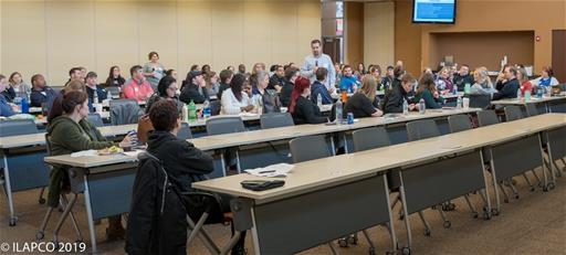 Seated Crowd Looks to Center Speaker