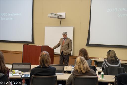 Man Stands at Podium
