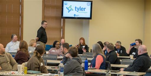 Woman gesticulating as she speaks at 2019 Leadership Symposium.