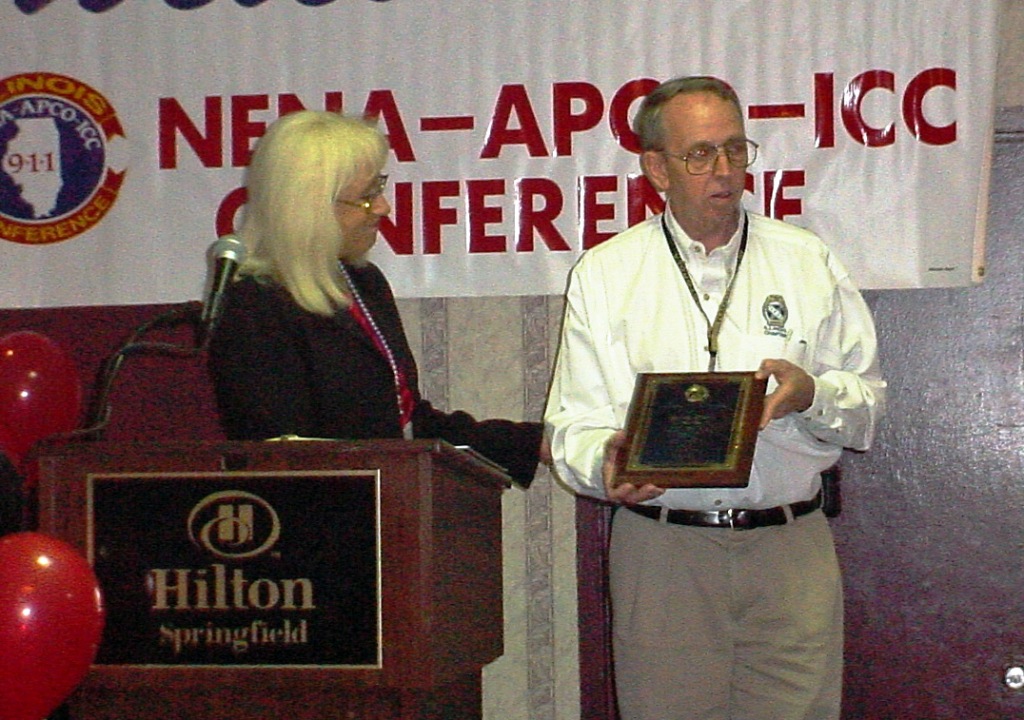 David Swan receives a Special Recognition Award from APCO's Chris Fischer Oct 2004 at IPSTA Conference 